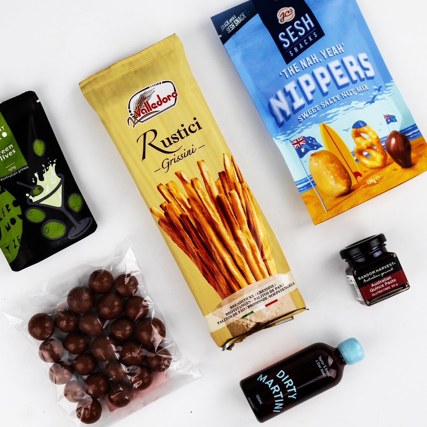 Dirty Martini cocktail bottle with Rustic Grissini breadsticks, The American Nippers crackers, chocolate-covered nuts, and.