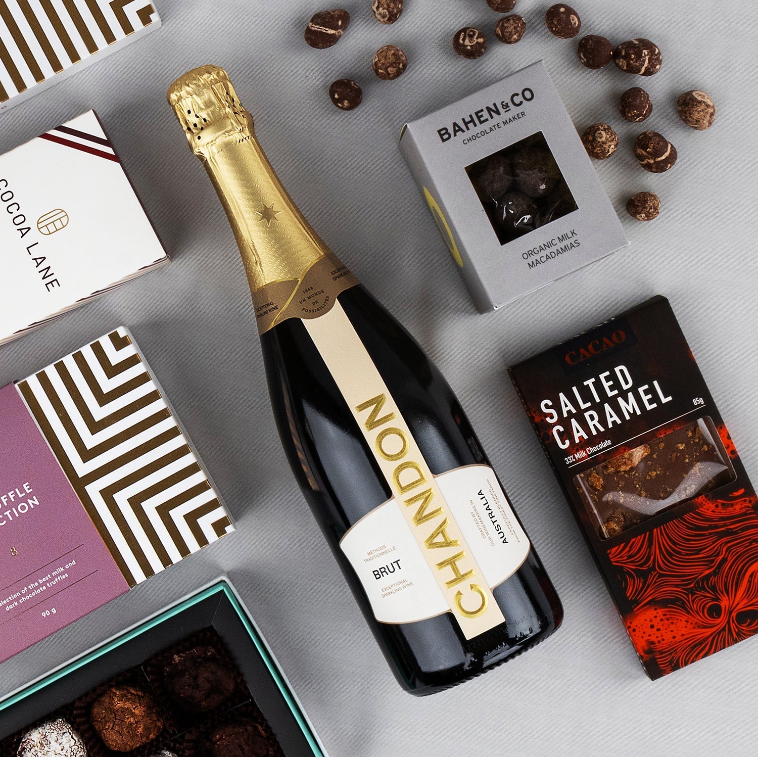 Chandon sparkling wine bottle with Bahen & Co chocolate box, salted caramel chocolate bar, and assorted truffles in gift.
